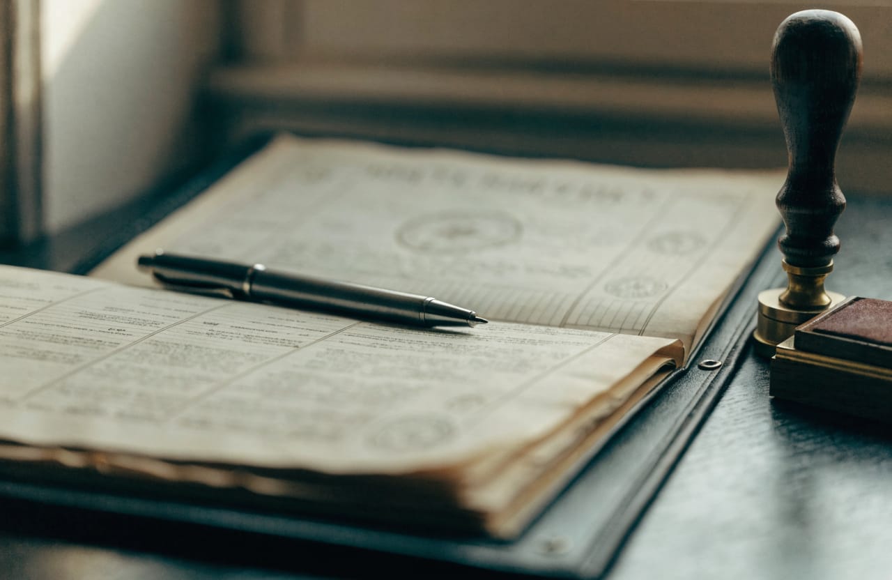 Desk with a title deed file, a seal and a fountain pen